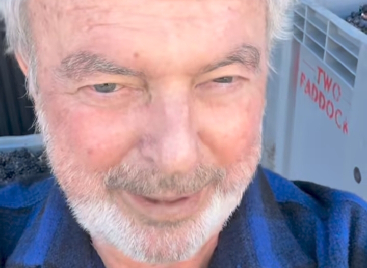 Sam Neill smiling at a public event before his passing