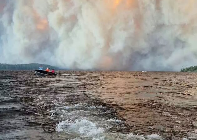 Orange sun caused by wildfire smoke over city skyline