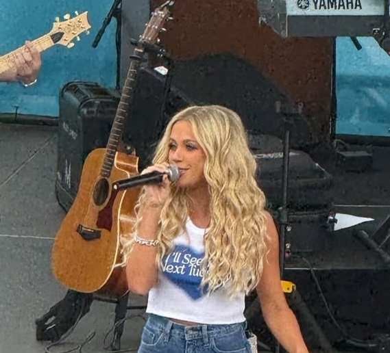 Fans cheering and supporting Megan Moroney during the emotional Denver concert.
