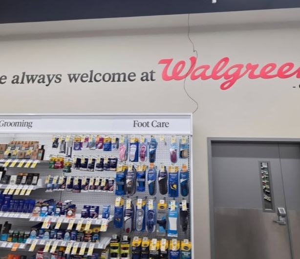 Customers walking outside a Walgreens pharmacy scheduled for closure.