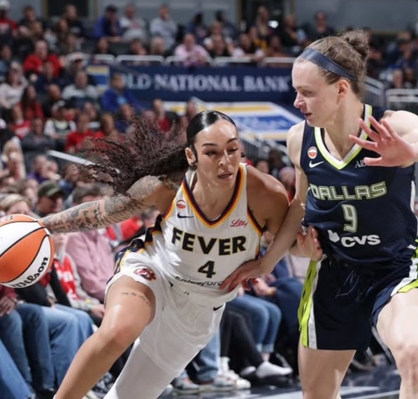 Indiana Fever and Las Vegas Aces battling for possession in a competitive WNBA matchup.