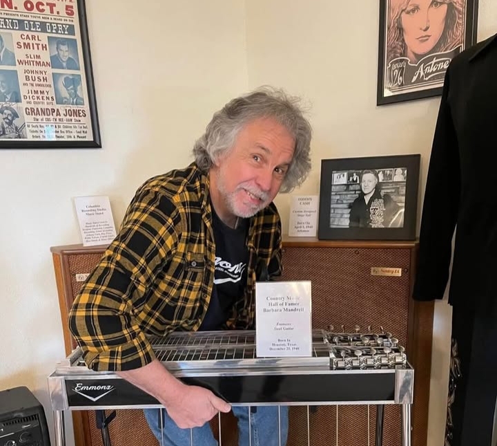 Tommy Detamore playing pedal steel guitar during a country music performance