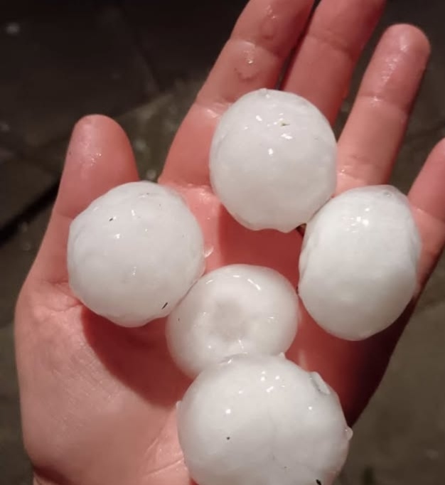 Grandine oggi with hailstones falling during a severe thunderstorm